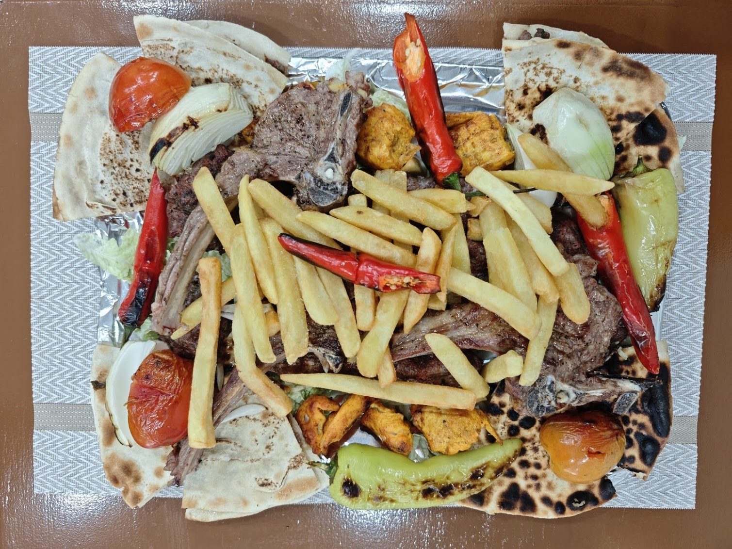A giant mixed grill platter of assorted char-grilled meats